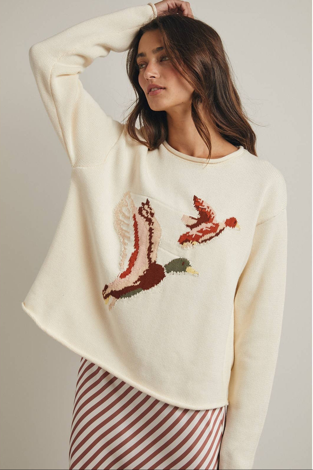 flying duck on cream colored knit sweater